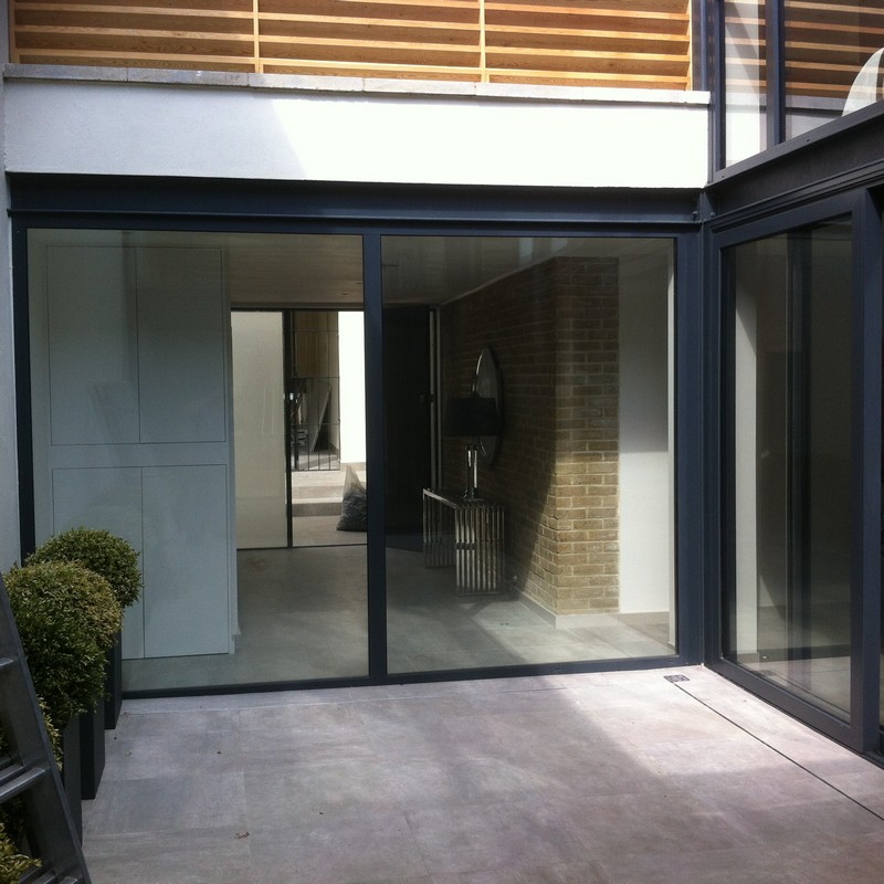Floor-to-ceiling sliding doors opening to courtyard in Purley