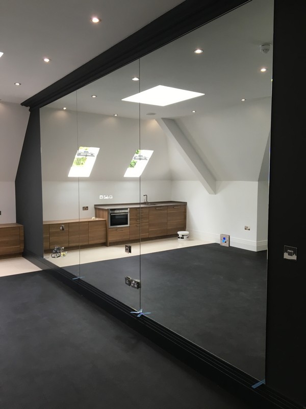 Frameless glass partition in loft conversion by Purley glaziers