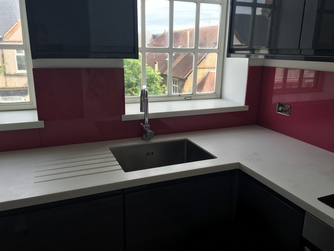 Deep plum coloured glass splashback in modern Purley kitchen