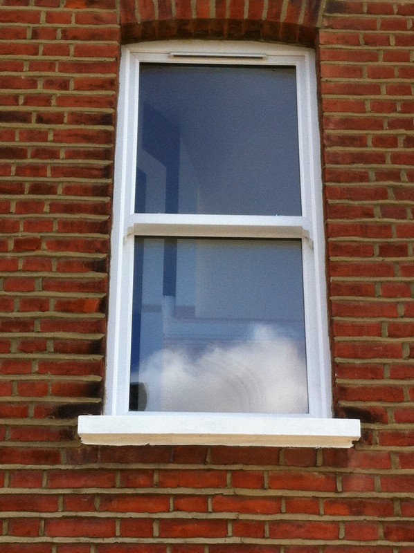 uPVC sash window on Victorian red brick house in Purley